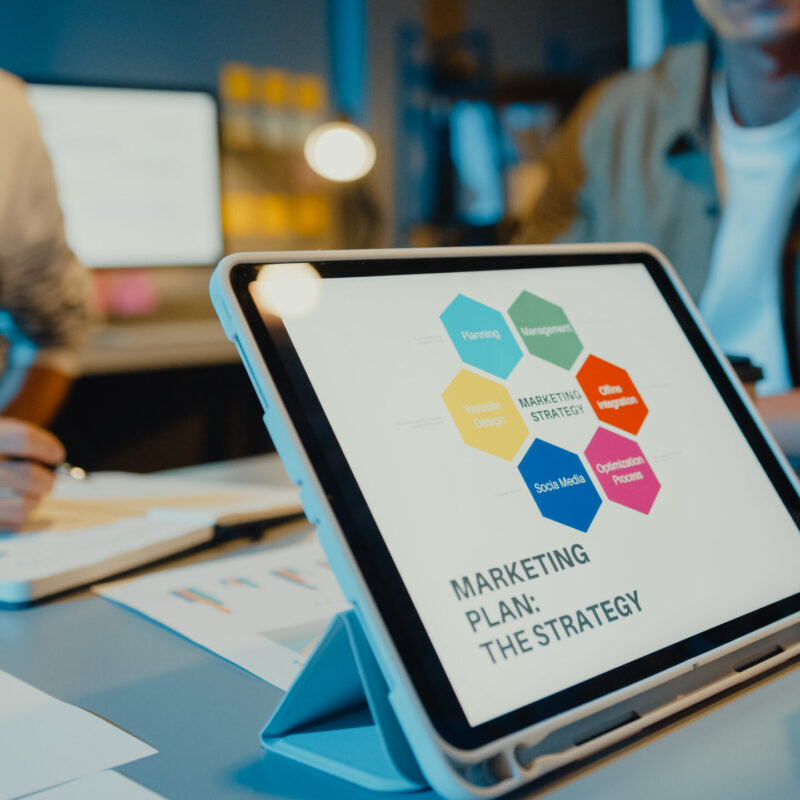 Asia businesspeople meeting plan analysis statistics brainstorm and header of team hold tablet point graph chart and employee take note in modern home office night. Finance strategy success concept.