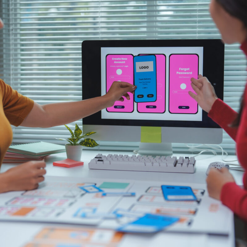 Two female web designers working together on user interface and user experience of mobile application