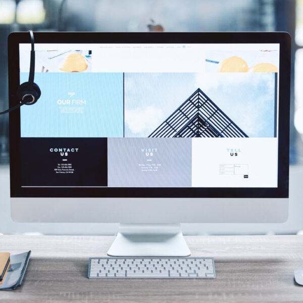 Webpage advert on computer desktop screen monitor in an empty call centre office. Operating helpdes.