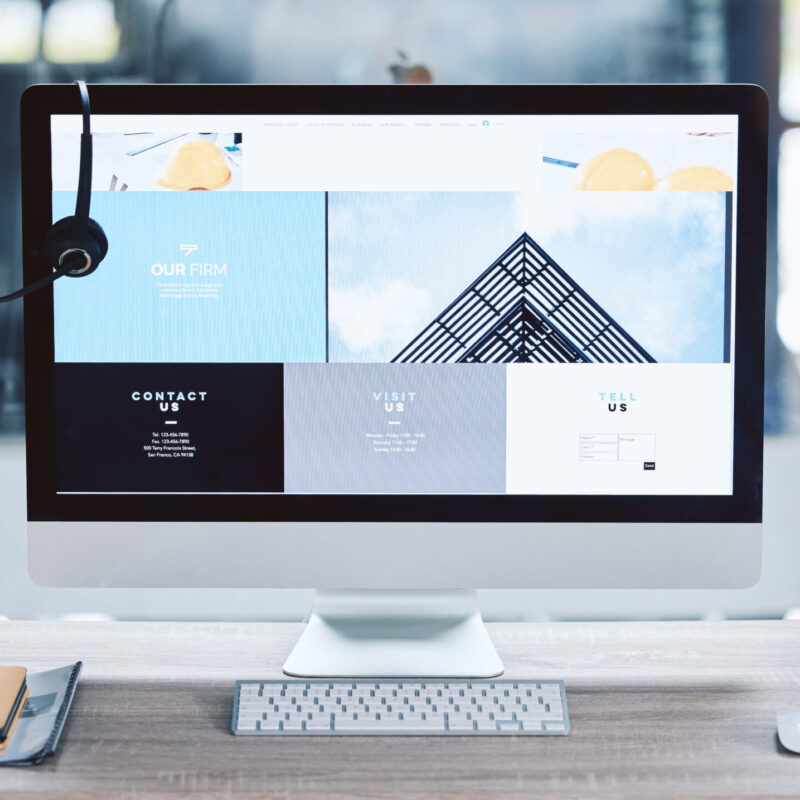 Webpage advert on computer desktop screen monitor in an empty call centre office. Operating helpdes.